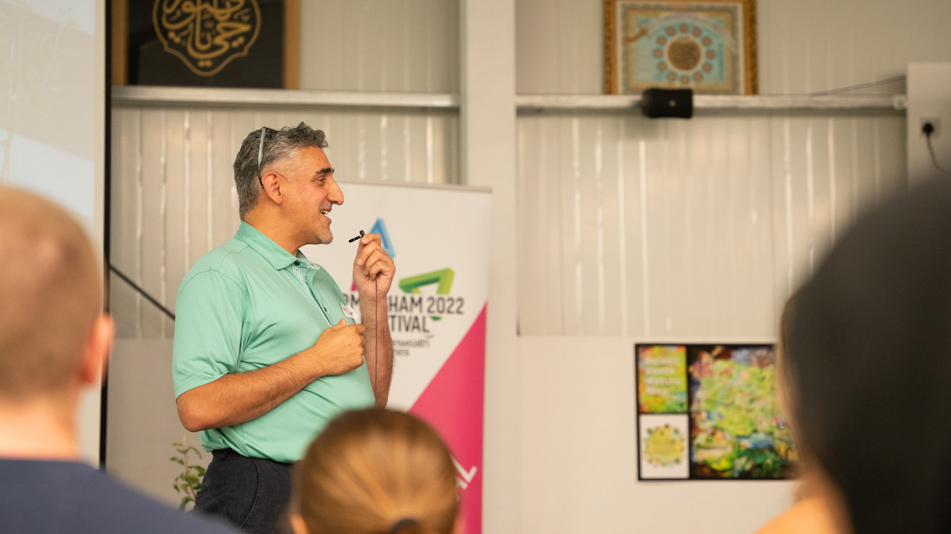 Abbas Shah speaking into a microphone