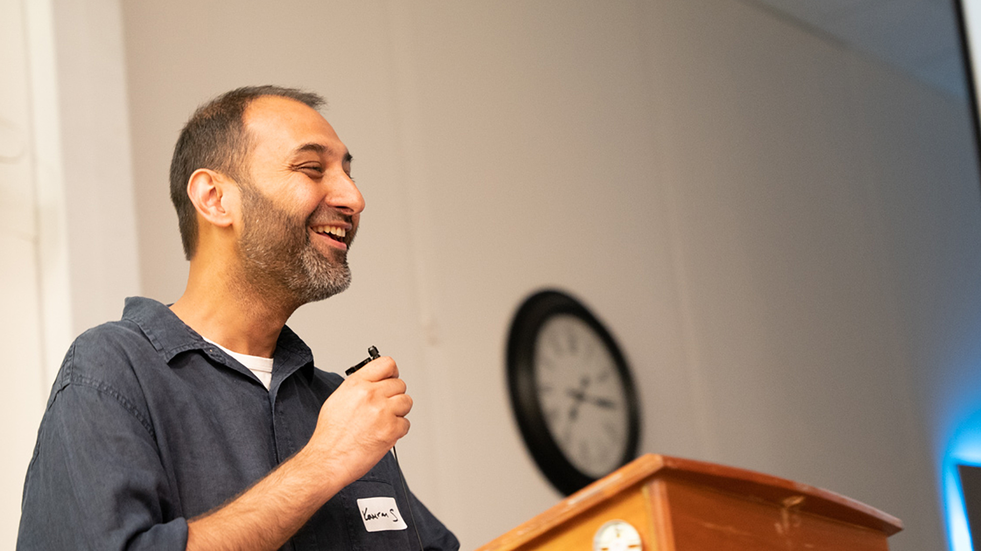 Kamran Shezad, a man with a beard and a microphone